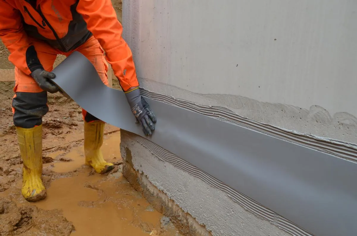 Joint tape embedded in epoxy adhesive along a wall base joint